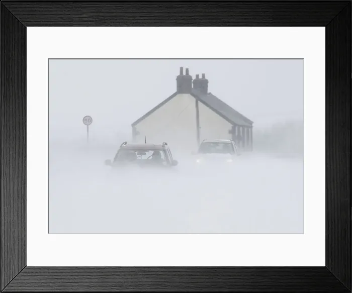 Framed Print : Motorists drive through snow blown from fields near Buxton in central England Framed Print : Motorists drive through snow blown from fields near Buxton in central England