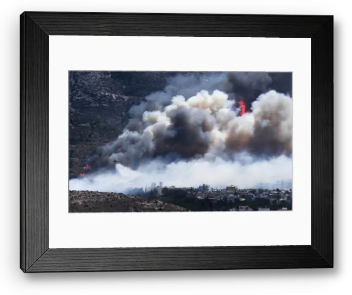Framed Print : A firefighting helicopter drops water on a raging wildfire at the Kareas suburb Framed Print : A firefighting helicopter drops water on a raging wildfire at the Kareas suburb