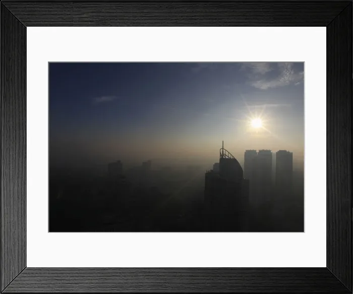 Framed Print : The sun shines on the first day of 2014 as smog from the New Year revelry covered high Framed Print : The sun shines on the first day of 2014 as smog from the New Year revelry covered high