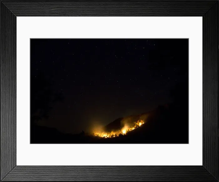 Framed Print : Fire blazes at the Jaragua Hills ecological reserve park under the night sky in Goias