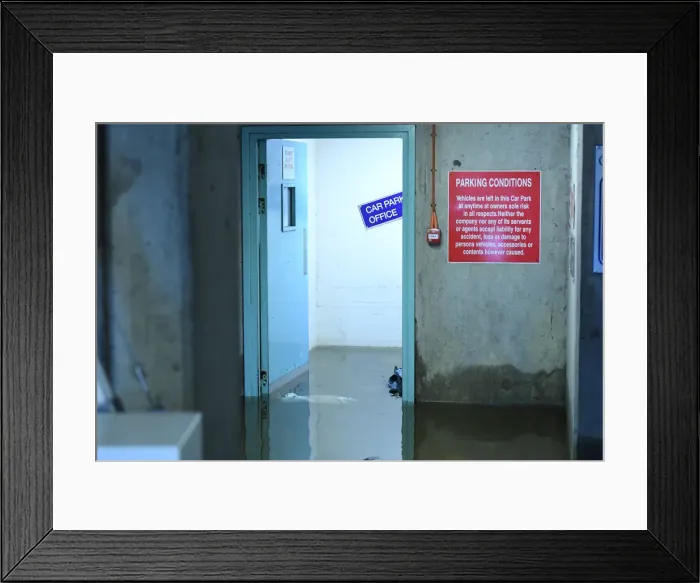 Framed Print : Flood water is seen at a doorway in a multi-storey car park as flood waters reached up to Framed Print : Flood water is seen at a doorway in a multi-storey car park as flood waters reached up to