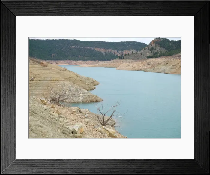 Framed Print : The partially empty Contreras water reservoir is pictured during a severe drought near Framed Print : The partially empty Contreras water reservoir is pictured during a severe drought near