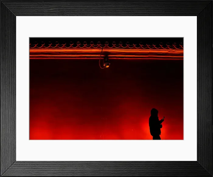Framed Print : A man walks away under a security camera after taking pictures of the super blue moon