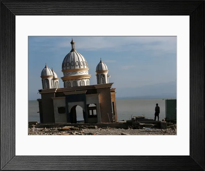 Framed Print : A police officer stands next to the remains of a mosque destroyed by the earthquake Framed Print : A police officer stands next to the remains of a mosque destroyed by the earthquake