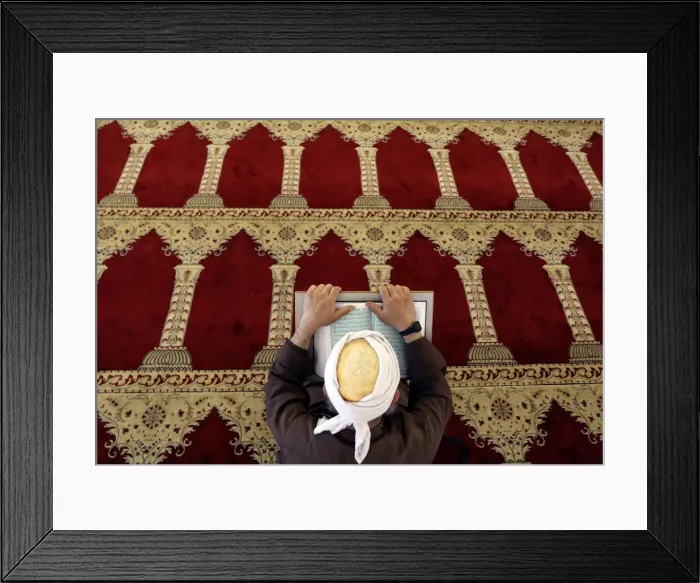 Framed Print : A Palestinian man reads the Koran in al-Aqsa Mosque, on the compound known to Muslims as Framed Print : A Palestinian man reads the Koran in al-Aqsa Mosque, on the compound known to Muslims as