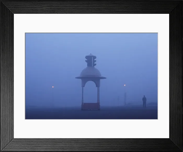 Framed Print : A man walks on a road amidst heavy fog on a winter morning in New Delhi