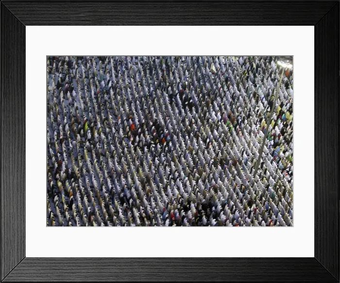 Framed Print : Muslim pilgrims attend a prayer session along a street at the surrounding area of Framed Print : Muslim pilgrims attend a prayer session along a street at the surrounding area of