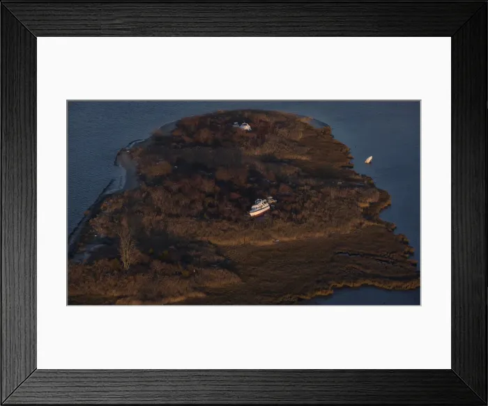 Framed Print : A boat sits in marshland, in this aerial view near Sea Bright, New Jersey