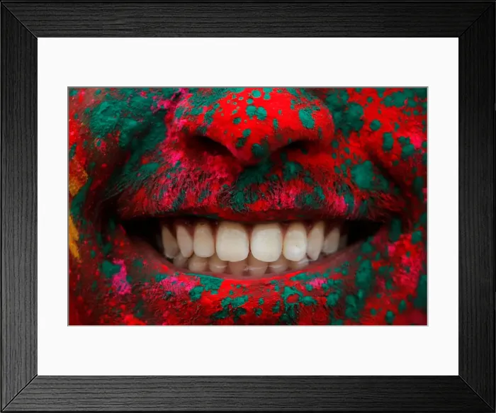 Framed Print : A person smiles after being covered in colored powder during a Holi festival party Framed Print : A person smiles after being covered in colored powder during a Holi festival party