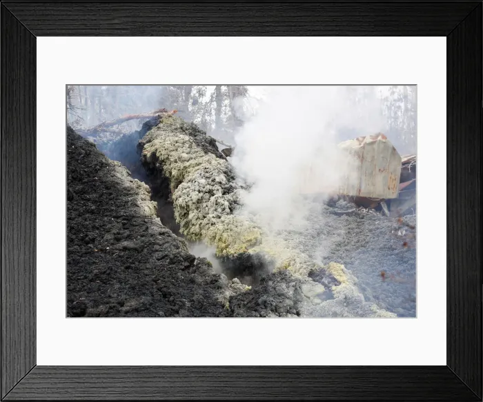 Framed Print : Volcanic gases rise from a fissure near the remains of a structure in the Leilani Estates Framed Print : Volcanic gases rise from a fissure near the remains of a structure in the Leilani Estates