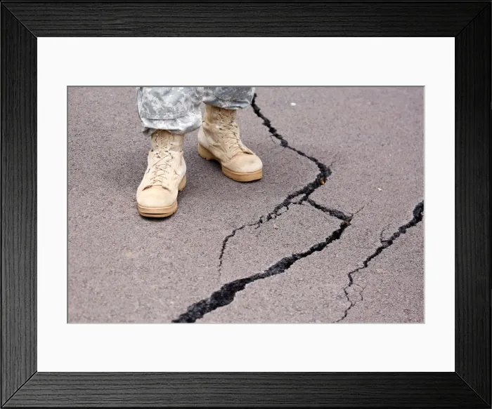 Framed Print : Cracks are visible along a road in the Leilani Estates subdivision during ongoing Framed Print : Cracks are visible along a road in the Leilani Estates subdivision during ongoing