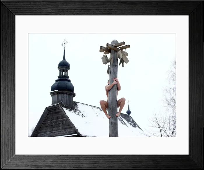 Framed Print : Man climbs up a wooden pole to get a prize during celebration of Maslenitsa Framed Print : Man climbs up a wooden pole to get a prize during celebration of Maslenitsa