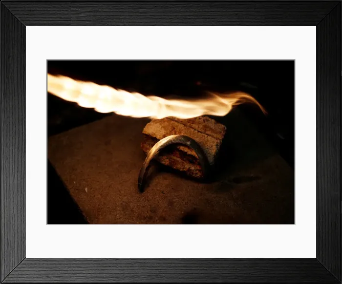 Framed Print : A piece of silver jewellery is seen during preparation in the workshop of goldsmith