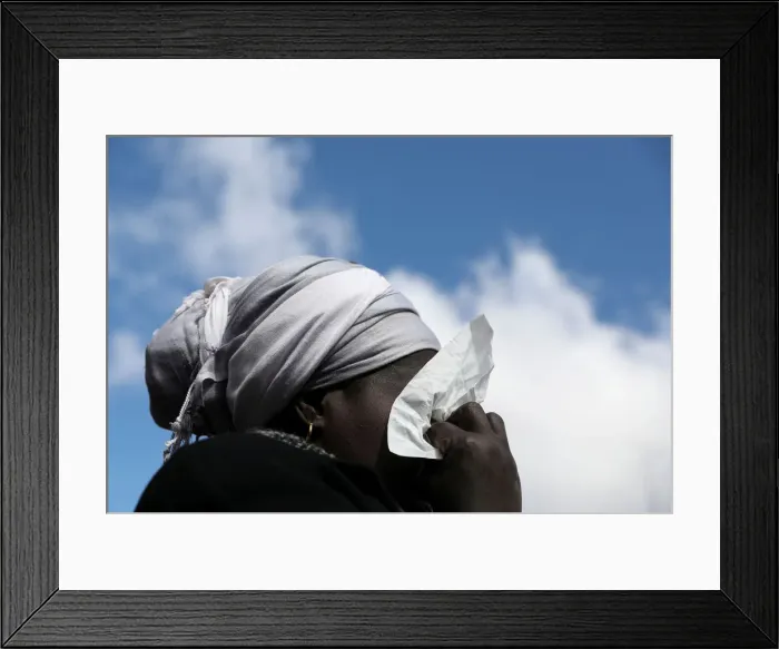 Framed Print : A woman cries as she attends a gathering to protest the death of a street hawker in Framed Print : A woman cries as she attends a gathering to protest the death of a street hawker in