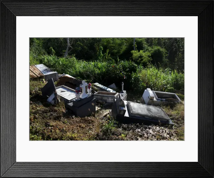 Framed Print : Graves destroyed during Hurricane Maria in September 2017, are seen at a cemetery Framed Print : Graves destroyed during Hurricane Maria in September 2017, are seen at a cemetery