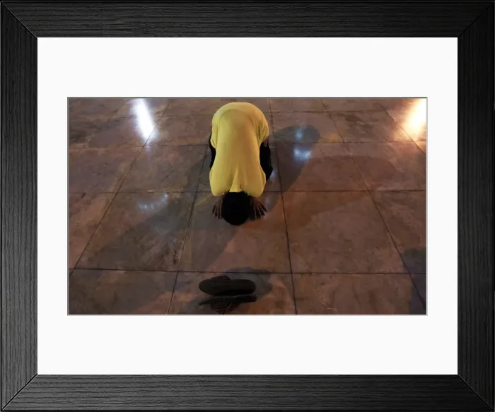 Framed Print : A Muslim man attends an evening prayer to mark the beginning of the holy fasting month of Framed Print : A Muslim man attends an evening prayer to mark the beginning of the holy fasting month of