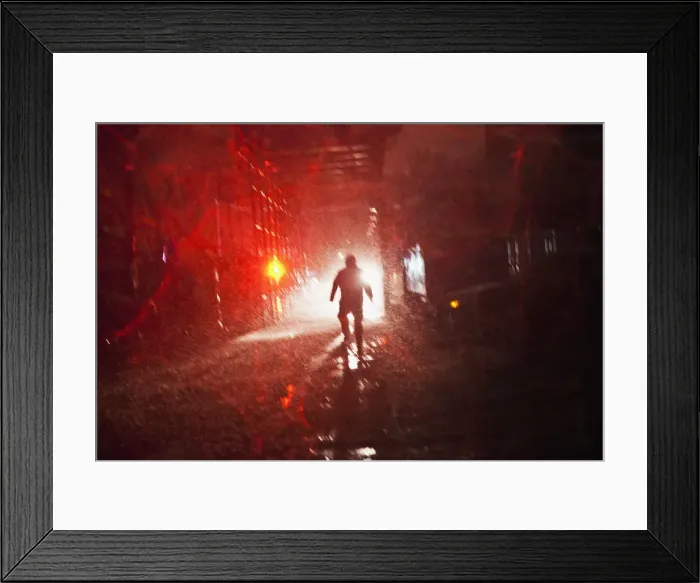 Framed Print : A man walks toward a police car during a nor easter, also known as a northeaster storm Framed Print : A man walks toward a police car during a nor easter, also known as a northeaster storm