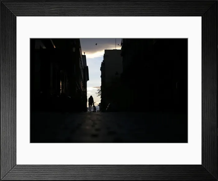 Framed Print : A woman walks with her bicycle in central Madrid