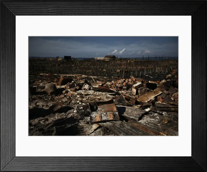 Framed Print : Destroyed items are scattered in the ruins of a neighborhood burnt in violence Framed Print : Destroyed items are scattered in the ruins of a neighborhood burnt in violence