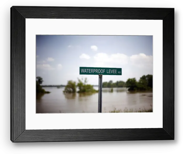 Framed Print : A sign is seen on a levee holding back the Mississippi River in Waterproof, Louisiana