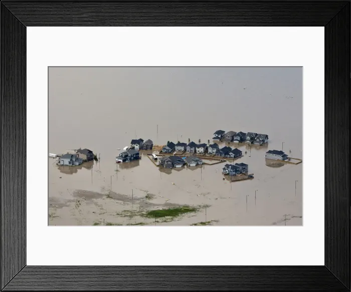 Framed Print : Houses are surrounded by flood water in High River