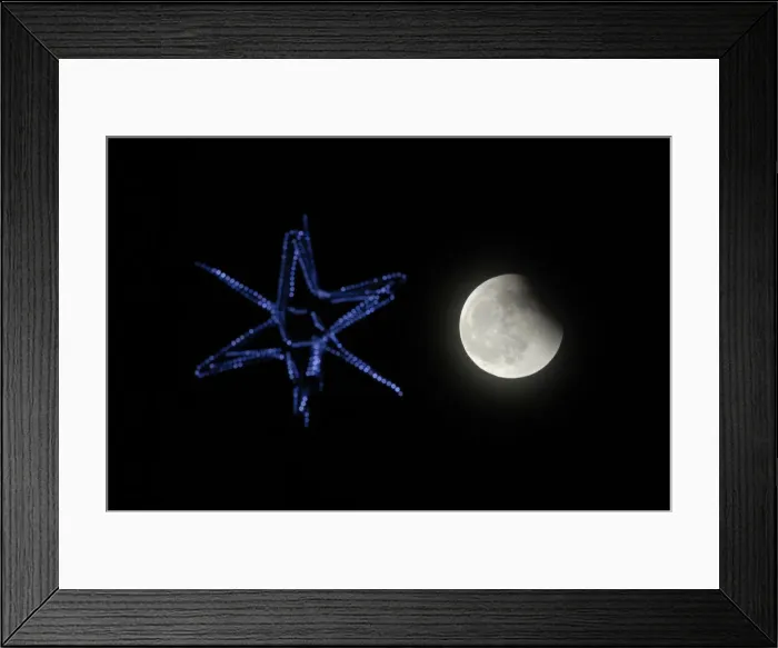 Framed Print : The shadow of the Earth falls across the face of the Moon above Russias far eastern city Framed Print : The shadow of the Earth falls across the face of the Moon above Russias far eastern city