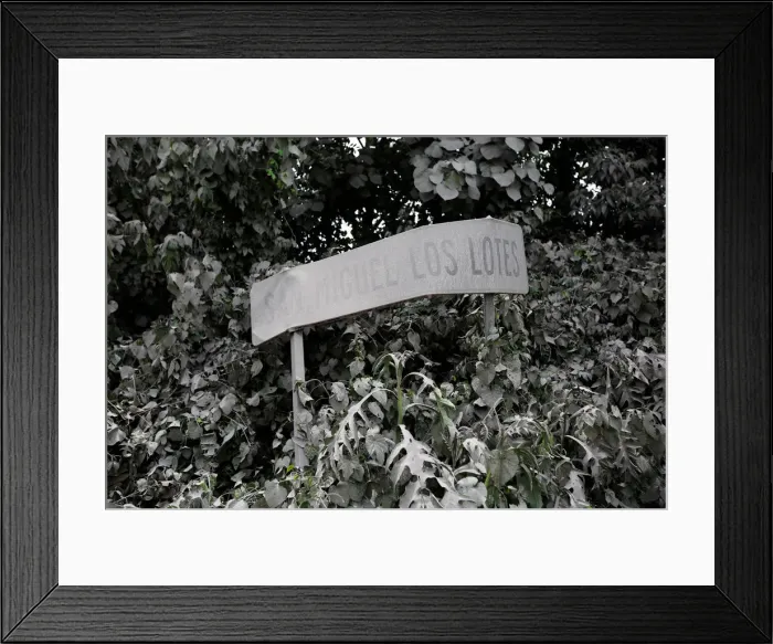 Framed Print : A road sign covered with ash is seen after Fuego volcano erupted in Escuintla Framed Print : A road sign covered with ash is seen after Fuego volcano erupted in Escuintla