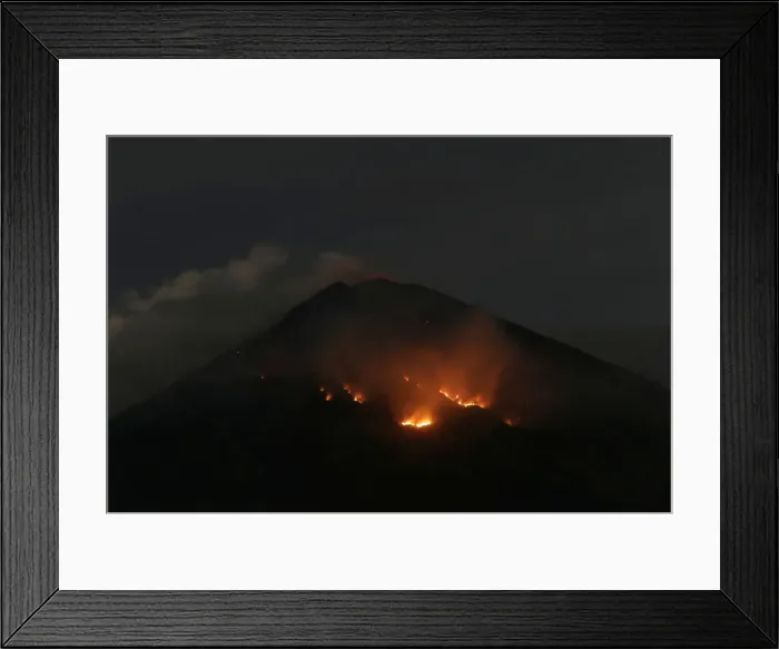 Framed Print : Fire is seen on the slopes of Mount Agung volcano following an eruption as seen from Amed Framed Print : Fire is seen on the slopes of Mount Agung volcano following an eruption as seen from Amed