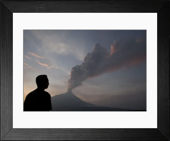 Framed Print : A villager looks at Mount Merapi spewing smoke and ash, at Ketep in Magelang Framed Print : A villager looks at Mount Merapi spewing smoke and ash, at Ketep in Magelang