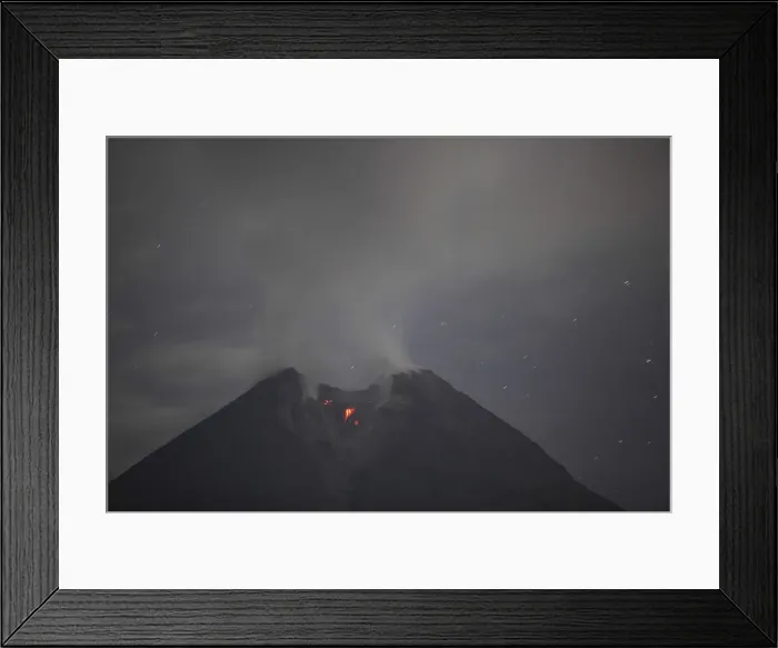 Framed Print : Mount Merapi volcano spews smoke as seen from Balerante village in Klaten Framed Print : Mount Merapi volcano spews smoke as seen from Balerante village in Klaten