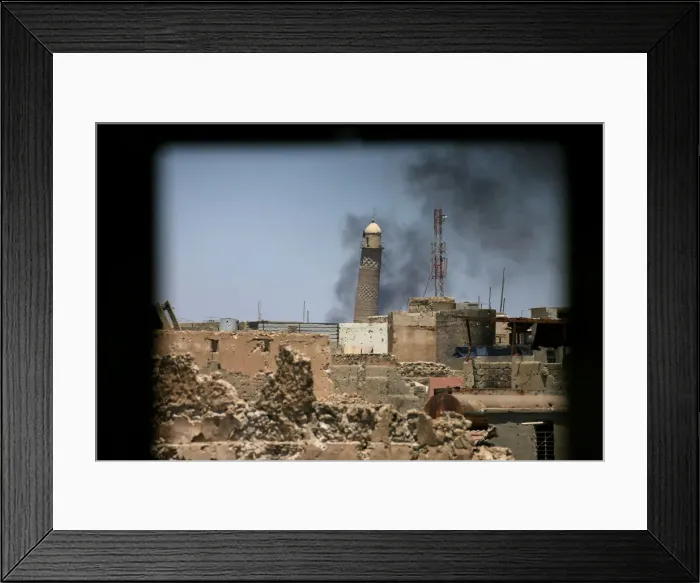 Framed Print : Al-Hadba minaret at the Grand Mosque is seen through a building window in the old city of Framed Print : Al-Hadba minaret at the Grand Mosque is seen through a building window in the old city of