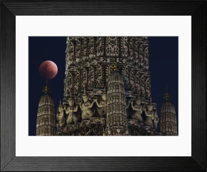 Framed Print : A super blood blue moon is seen during an eclipse at a temple in Bangkok Framed Print : A super blood blue moon is seen during an eclipse at a temple in Bangkok