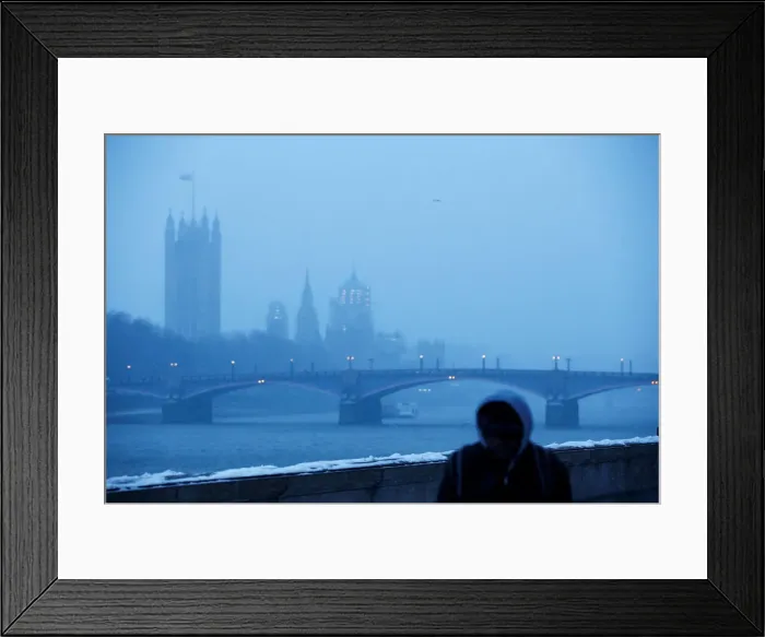 Framed Print : A man walks along the South Bank of the Thames during a snow storm in London Framed Print : A man walks along the South Bank of the Thames during a snow storm in London
