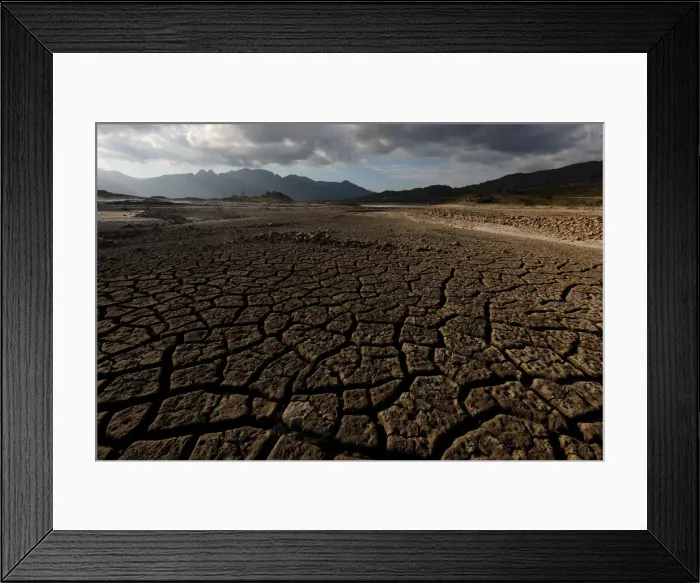 Framed Print : Sand blows across a normally submerged area at Theewaterskloof dam near Cape Town