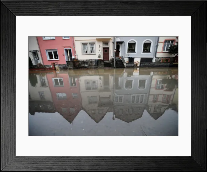 Framed Print : Houses are reflected in the waters of the river Moselle after the river flooded