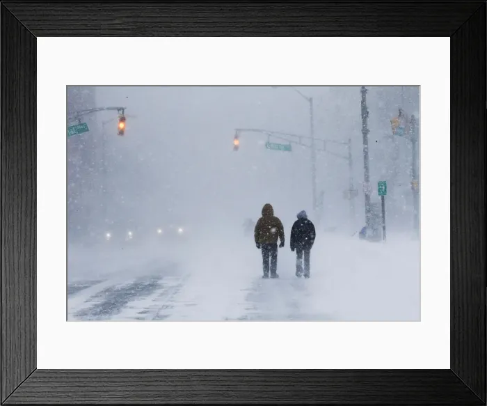 Framed Print : People struggle against wind and snow during Storm Grayson at the Jersey shore in Long Framed Print : People struggle against wind and snow during Storm Grayson at the Jersey shore in Long