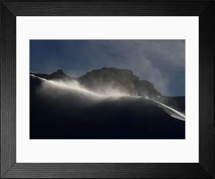 Framed Print : Strong winds blow snow on a ridge in Adelboden
