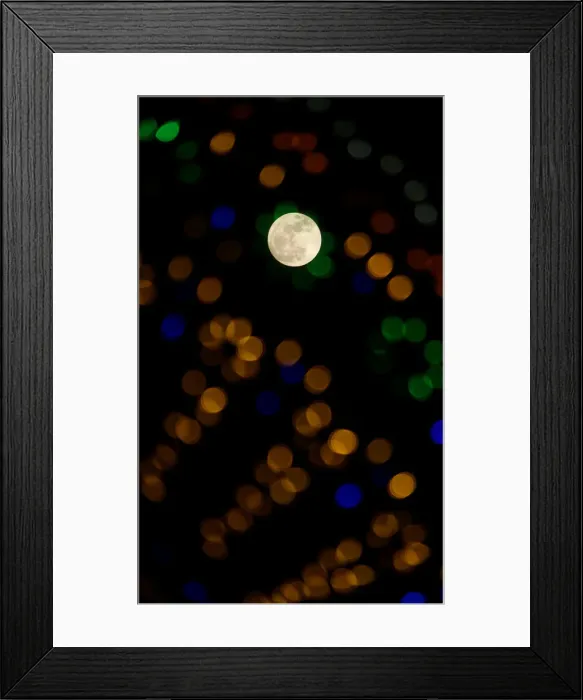 Framed Print : The supermoon full moon is seen through Christmas lights in Valletta