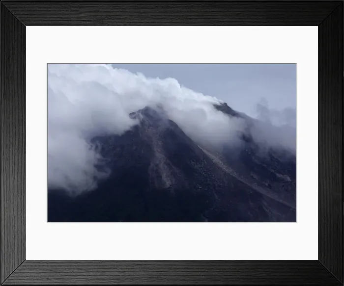 Framed Print : Mount Merapi volcano emits smoke as it is seen from Kinahrejo village near Yogyakarta Framed Print : Mount Merapi volcano emits smoke as it is seen from Kinahrejo village near Yogyakarta