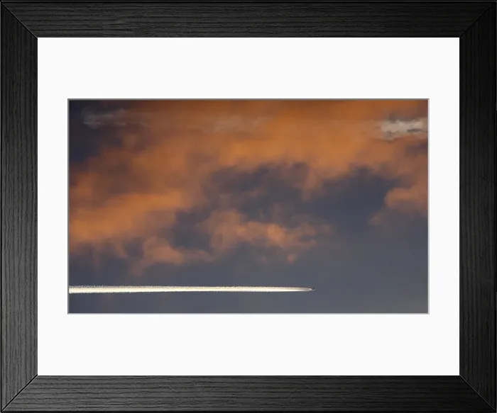Framed Print : An aircraft flies above Russias Siberian city of Krasnoyarsk during sunset