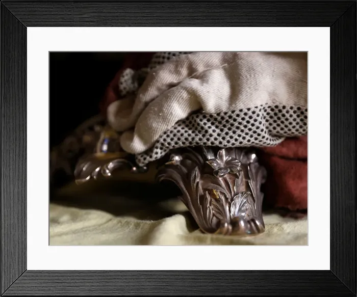 Framed Print : A woman polishes an antique silver candelabra at her home in Valletta