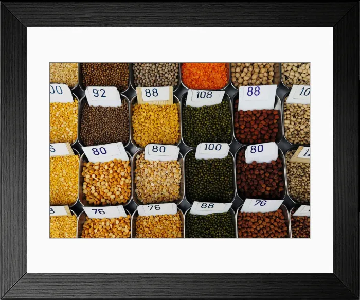 Framed Print : Price tags are seen on the samples of pulses that are kept on display for sale at a