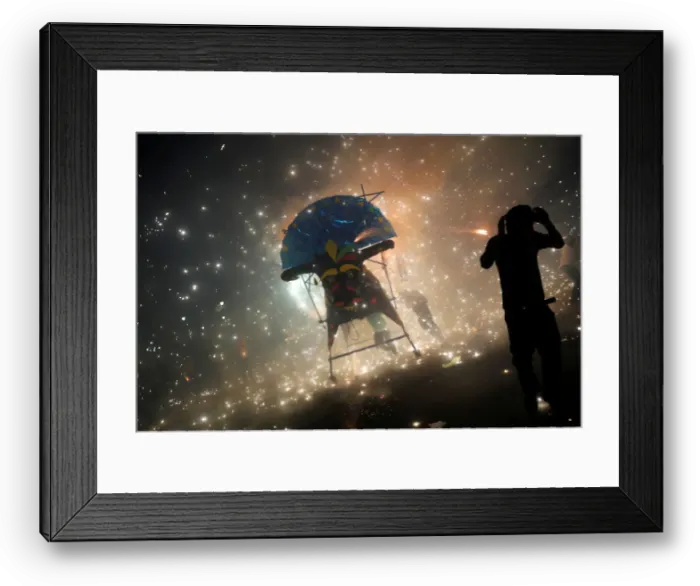 Framed Print : Man enjoys the fireworks exploding from a traditional bull figure known as El Torito in Framed Print : Man enjoys the fireworks exploding from a traditional bull figure known as El Torito in