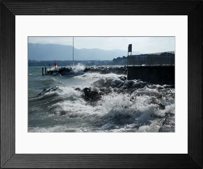 Framed Print : Waves splash on the shore during a windy winter day near Lake Leman in Geneva