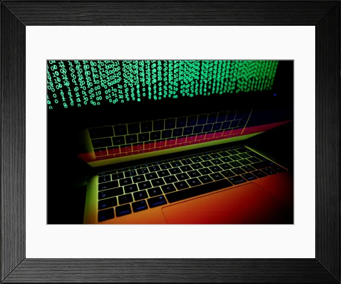 Framed Print : German flag is seen on the laptop screen in front of a computer screen on which cyber Framed Print : German flag is seen on the laptop screen in front of a computer screen on which cyber
