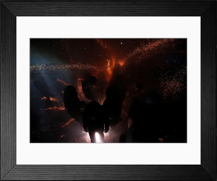 Framed Print : Participants wearing motorcycle helmets get sprayed with firecrackers Framed Print : Participants wearing motorcycle helmets get sprayed with firecrackers