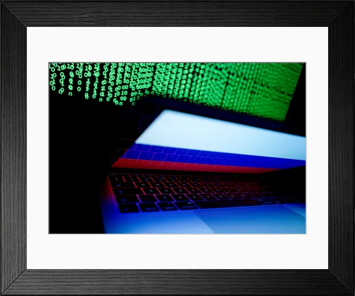 Framed Print : Russian flag is seen on the laptop screen in front of a computer screen on which cyber Framed Print : Russian flag is seen on the laptop screen in front of a computer screen on which cyber