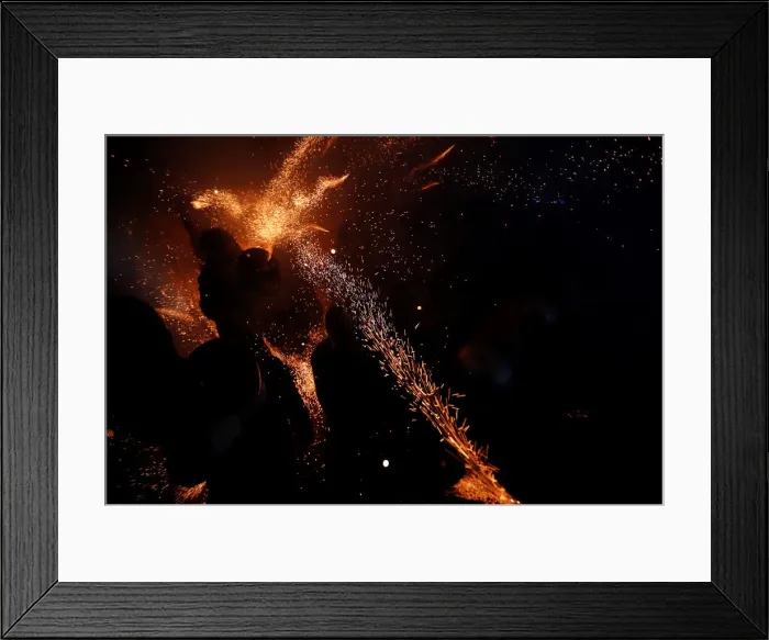Framed Print : Participants wearing motorcycle helmets get sprayed with firecrackers Framed Print : Participants wearing motorcycle helmets get sprayed with firecrackers