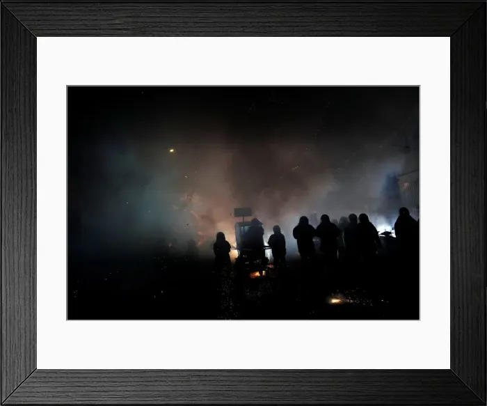 Framed Print : Participants wearing motorcycle helmets get sprayed with firecrackers Framed Print : Participants wearing motorcycle helmets get sprayed with firecrackers