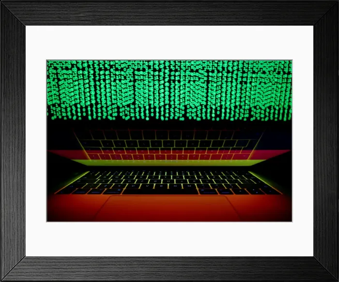 Framed Print : German flag is seen on the laptop screen in front of a computer screen on which cyber Framed Print : German flag is seen on the laptop screen in front of a computer screen on which cyber